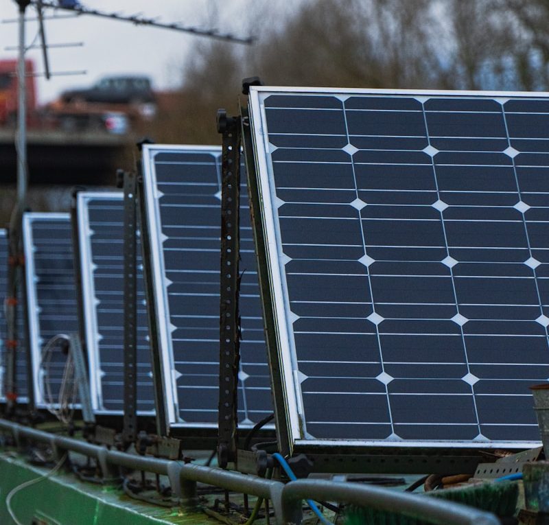 blue solar panels on green metal frame